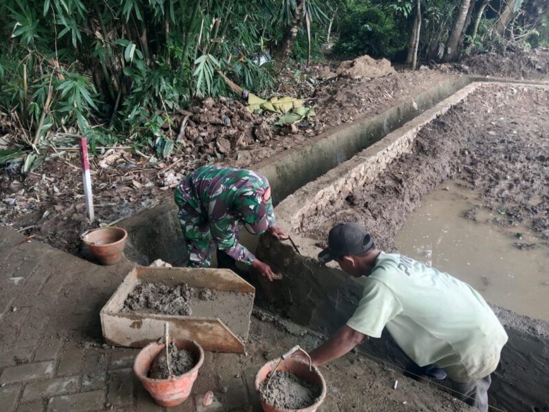 Foto : Babinsa Koramil 1002-03/Haruyan, Sertu Sutoyo, melaksanakan kegiatan gotong royong bersama warga Desa Hapulang dalam pembangunan irigasi tersier 
