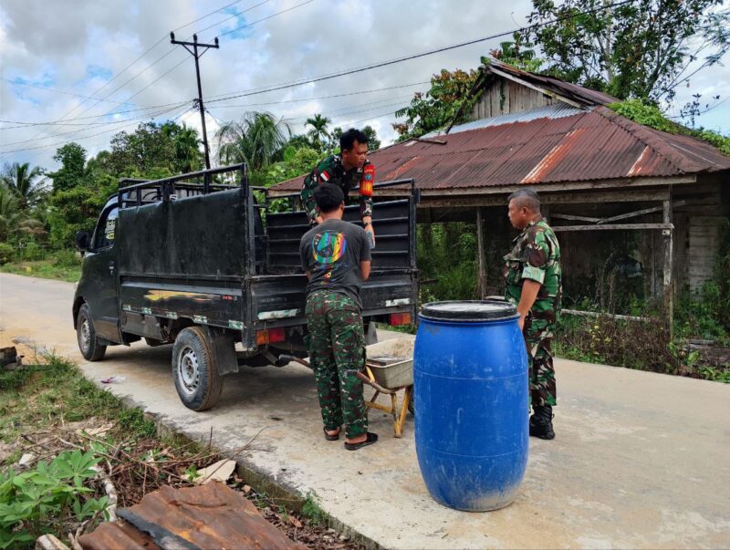 Foto : Para prajurit bersama warga setempat bergotong royong mengangkut keramik yang akan digunakan untuk pembangunan MCK Rumah Tidak Layak Huni (RTLH)